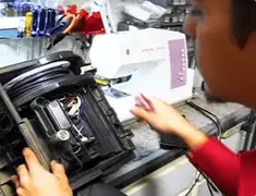 Vacuum repair technician servicing internal components on a workbench in Lakeland, FL