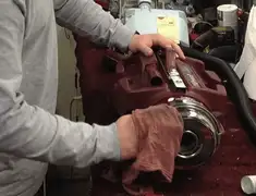 Vacuum repair technician cleaning and servicing a vacuum motor in Lakeland, FL