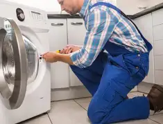 Washing machine repair technician servicing a front-load washer in Lakeland, FL